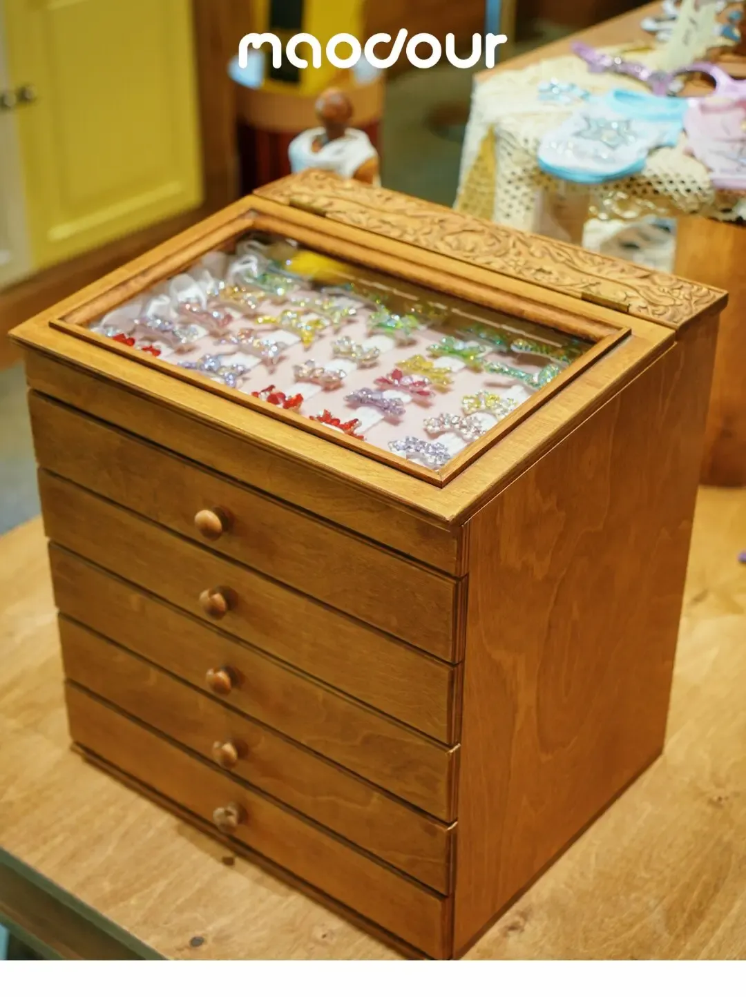 Pull-out pet jewelry trays in a wooden organizer