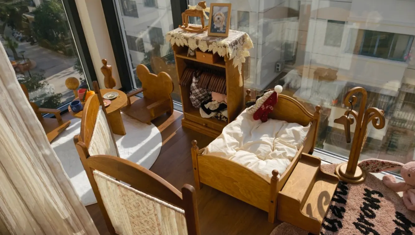 A wooden pet bed with stairs for easier bedroom access at night